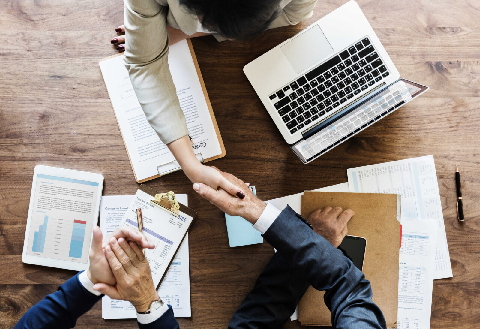 business-people-shaking-hands-together_optimized